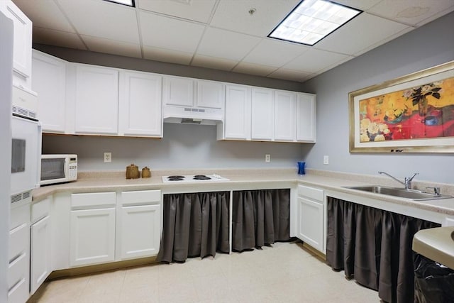 211 Central St Unit A305, Norwood, MA 02062 - kitchen with white appliances, under cabinet range hood, a drop ceiling, white cabinetry, and light countertops