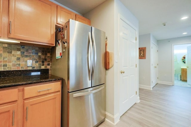 211 Central St Unit A305, Norwood, MA 02062 - kitchen with freestanding refrigerator, dark stone countertops, backsplash, recessed lighting, and light wood finished floors