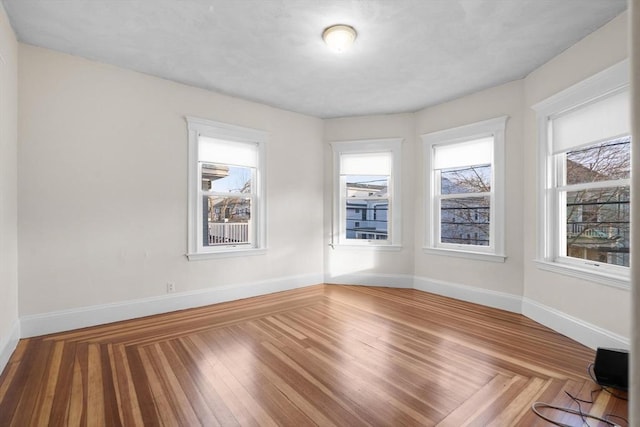 unfurnished room with wood-type flooring