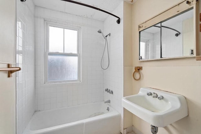 bathroom featuring tiled shower / bath and sink