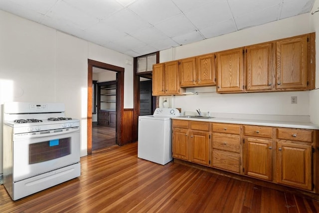 kitchen with a paneled ceiling, washer / clothes dryer, sink, white gas stove, and dark hardwood / wood-style floors