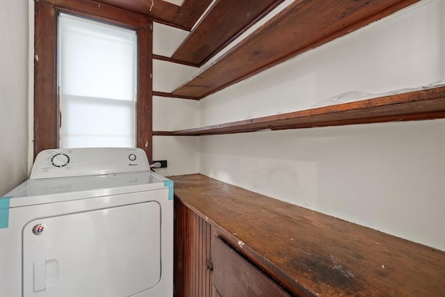 laundry area with washer / dryer and cabinets