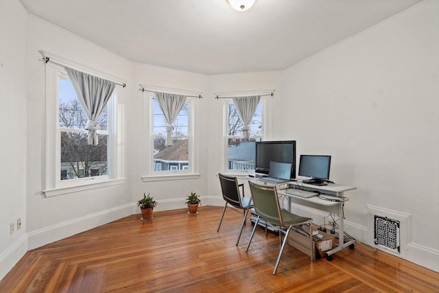 office with hardwood / wood-style flooring and plenty of natural light