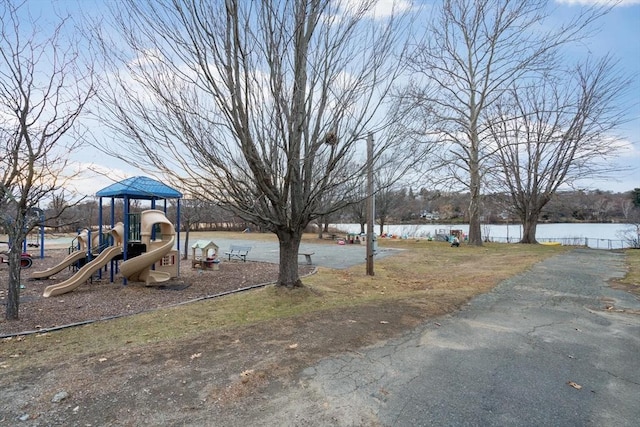 view of yard featuring a water view and a playground