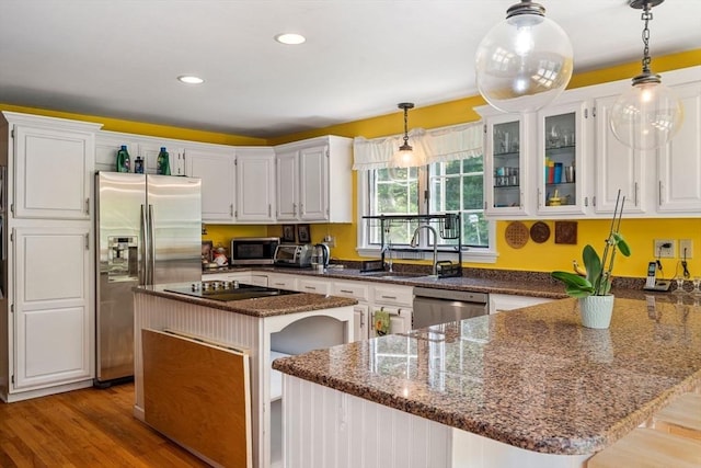 25 Brandt Beach Ave, Mattapoisett, MA 02739 - kitchen featuring stainless steel appliances, dark stone counters, white cabinets, a peninsula, and recessed lighting