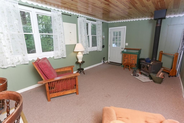 14 Cormack Rd, Sturbridge, MA 01566 - living area with carpet, a wood stove, baseboards, and wood ceiling