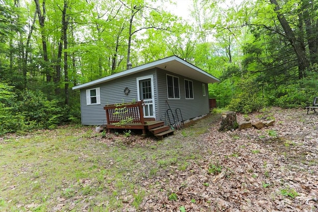 14 Cormack Rd, Sturbridge, MA 01566 - view of front of property featuring a wooden deck and a view of trees