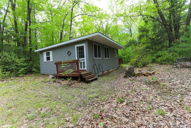 14 Cormack Rd, Sturbridge, MA 01566 - view of front of home with a wooden deck and a forest view