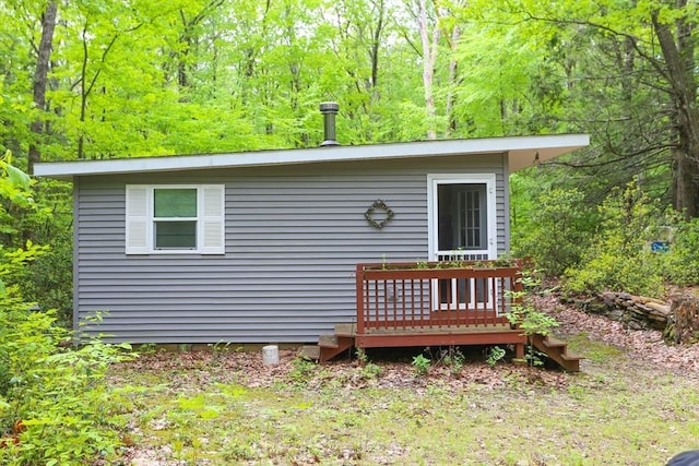 14 Cormack Rd, Sturbridge, MA 01566 - rear view of house featuring a wooden deck and a view of trees