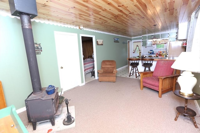 14 Cormack Rd, Sturbridge, MA 01566 - living room featuring a wood stove, carpet, wooden ceiling, and baseboards
