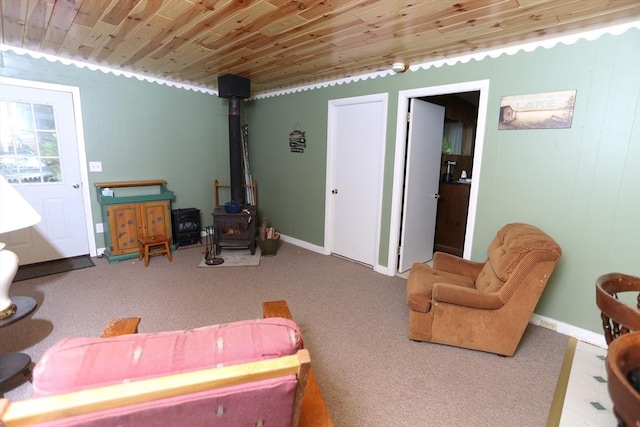 14 Cormack Rd, Sturbridge, MA 01566 - living room featuring a wood stove, wood ceiling, carpet flooring, and baseboards