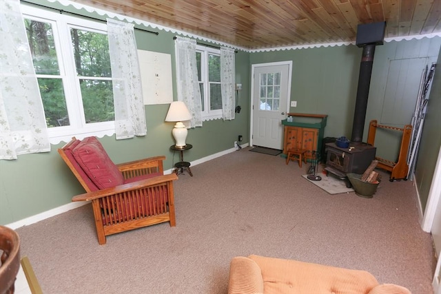 14 Cormack Rd, Sturbridge, MA 01566 - living area with a wood stove, carpet, baseboards, and wood ceiling