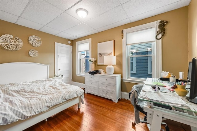 21 Sudan St, Boston, MA 02125 - bedroom with a drop ceiling, wood finished floors, multiple windows, and baseboards