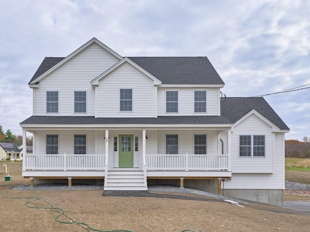 view of front facade with a porch and roof with shingles