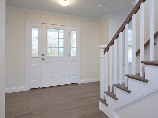 foyer featuring stairs, baseboards, dark wood-type flooring, and crown molding