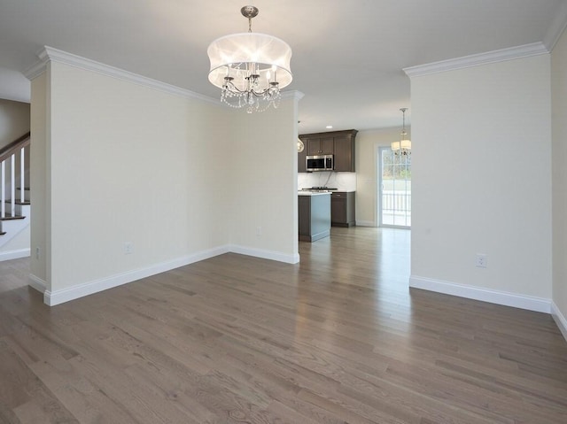 unfurnished living room with a chandelier, stairs, and dark wood-style floors