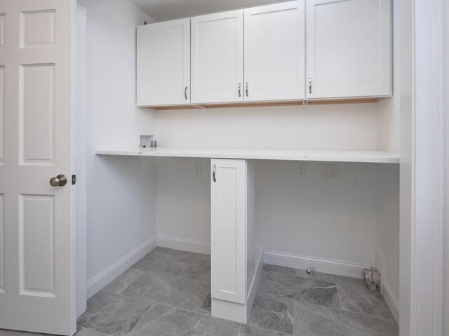 laundry room featuring hookup for a washing machine, marble finish floor, cabinet space, and baseboards