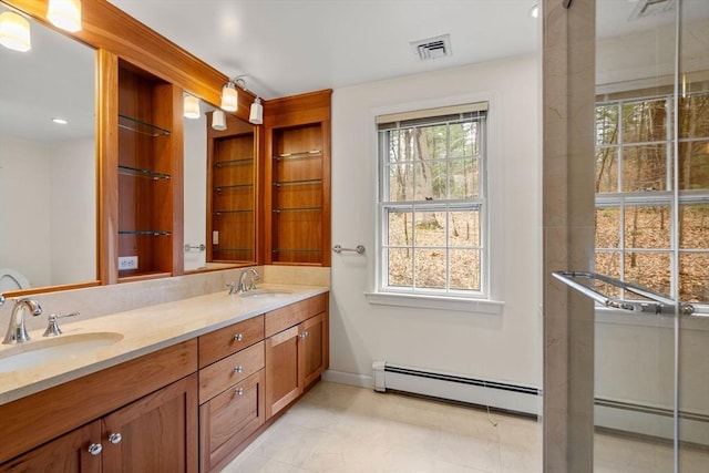 full bath with double vanity, baseboards, visible vents, and a sink