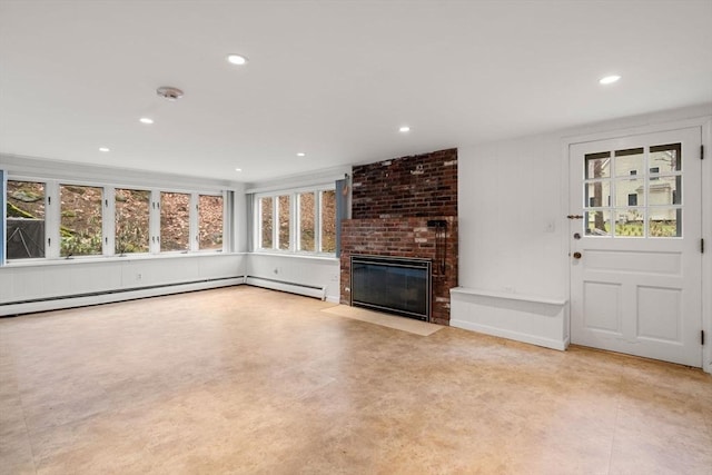 unfurnished living room with recessed lighting, concrete floors, baseboard heating, and a fireplace