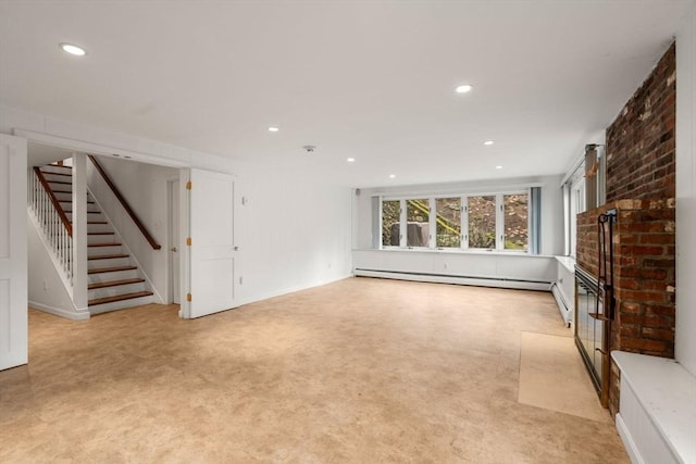 unfurnished living room with a brick fireplace, recessed lighting, stairway, and a baseboard radiator
