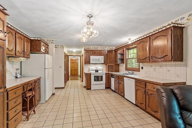 4 Clarke Rd, Littleton, MA 01460 - kitchen featuring white appliances, tile countertops, a sink, tasteful backsplash, and a chandelier