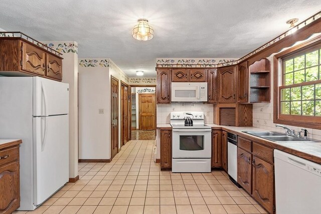 4 Clarke Rd, Littleton, MA 01460 - kitchen featuring white appliances, a sink, backsplash, tile counters, and light tile patterned floors