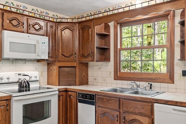 4 Clarke Rd, Littleton, MA 01460 - kitchen featuring white appliances, a sink, tile countertops, a textured ceiling, and tasteful backsplash