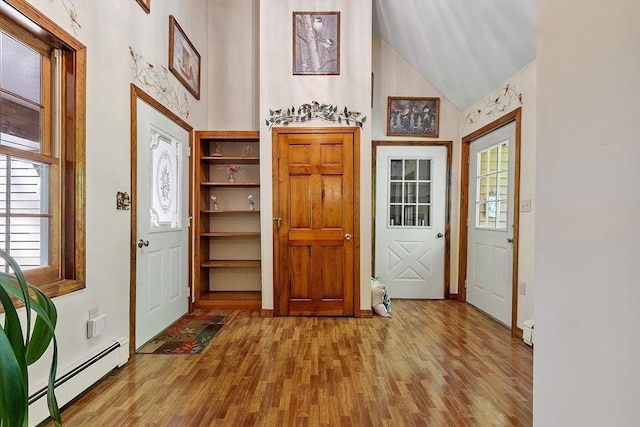 4 Clarke Rd, Littleton, MA 01460 - foyer featuring a baseboard radiator, wood finished floors, healthy amount of natural light, lofted ceiling, and baseboards