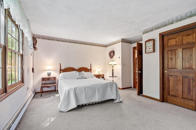 4 Clarke Rd, Littleton, MA 01460 - bedroom featuring a baseboard heating unit, baseboards, and light colored carpet