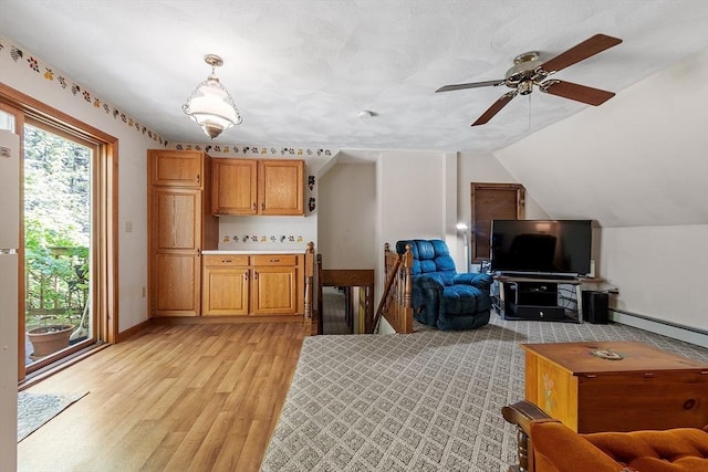 4 Clarke Rd, Littleton, MA 01460 - kitchen with light wood-style flooring, ceiling fan, light countertops, baseboard heating, and open floor plan