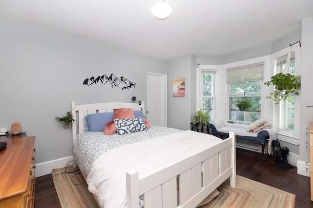 bedroom featuring dark wood-type flooring and multiple windows