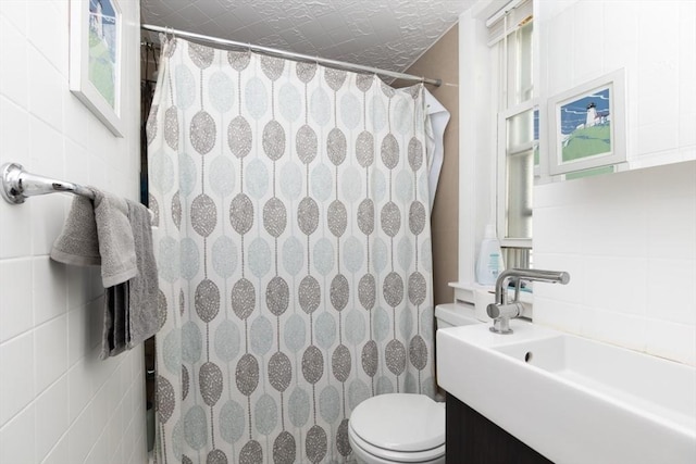 bathroom with a shower with shower curtain, vanity, toilet, and a wealth of natural light