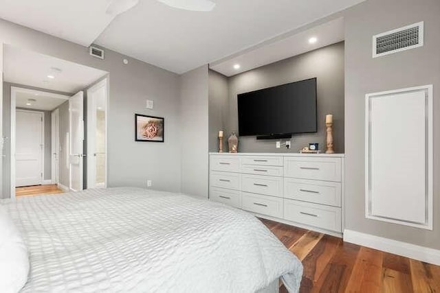 bedroom with recessed lighting, wood finished floors, visible vents, and baseboards