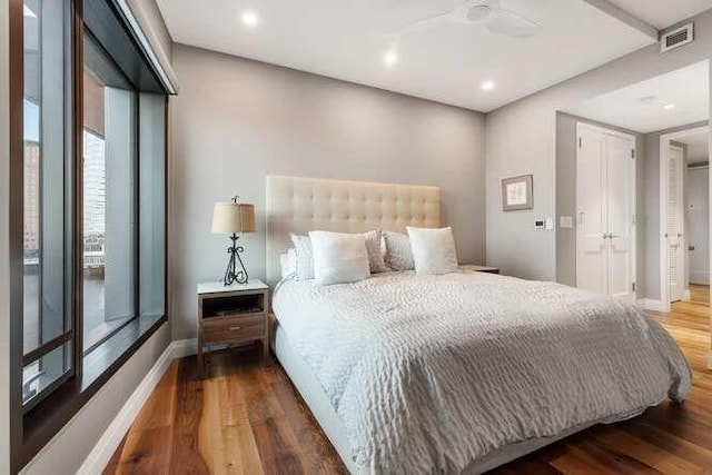 bedroom featuring recessed lighting, visible vents, baseboards, and wood finished floors