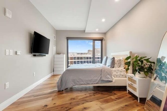 bedroom with recessed lighting, baseboards, and wood finished floors