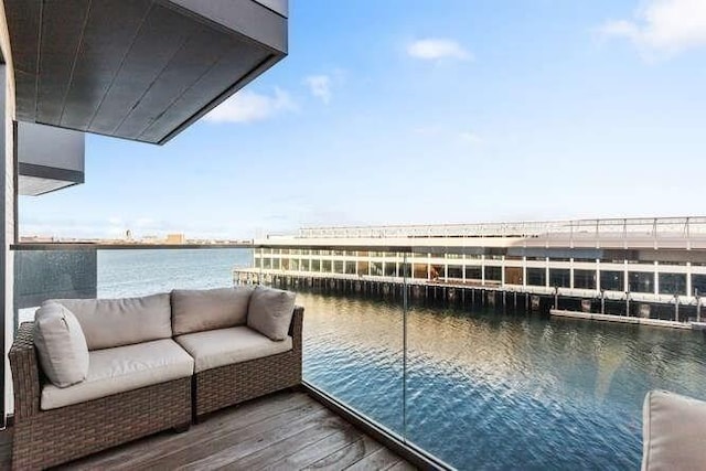 dock area featuring a water view and a balcony