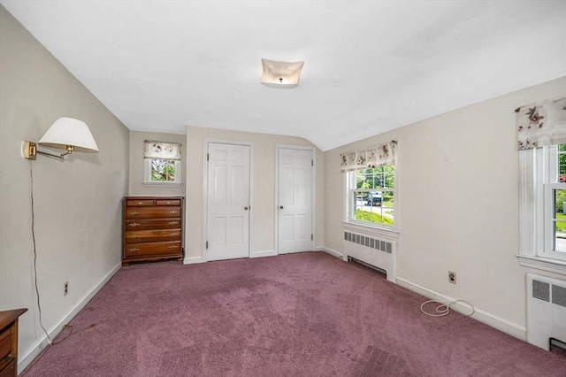 146 Elm St, Andover, MA 01810 - unfurnished bedroom with radiator, baseboards, carpet floors, lofted ceiling, and multiple closets