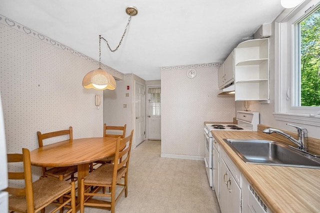146 Elm St, Andover, MA 01810 - kitchen featuring white range with electric cooktop, under cabinet range hood, a sink, open shelves, and wallpapered walls