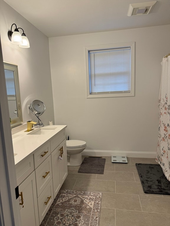 bathroom featuring toilet, vanity, and tile patterned floors