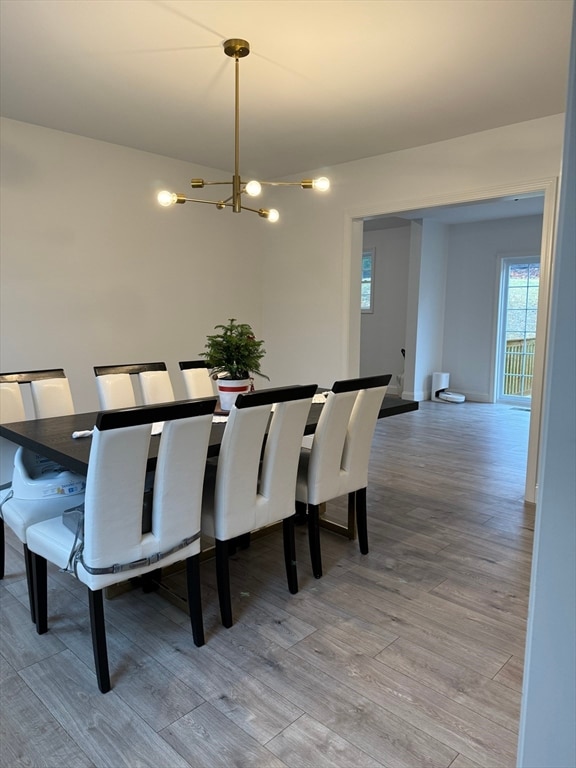 dining room featuring a chandelier and light hardwood / wood-style flooring