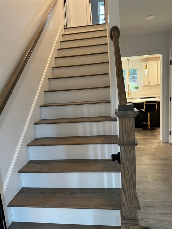 staircase featuring hardwood / wood-style flooring