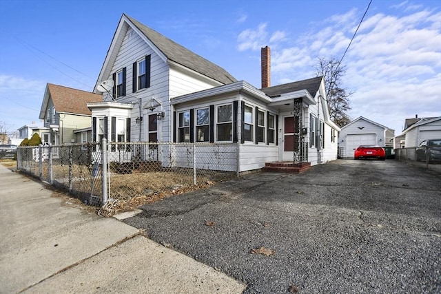 view of home's exterior featuring an outdoor structure and a garage