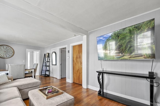 living room featuring dark hardwood / wood-style flooring and ornamental molding