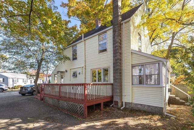 back of property with a wooden deck