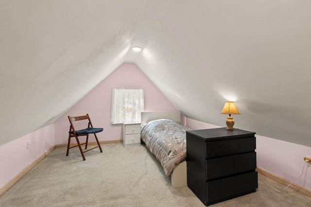 carpeted bedroom with vaulted ceiling and baseboards