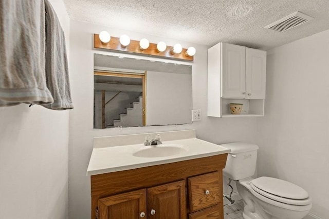 full bathroom with toilet, a textured ceiling, visible vents, and vanity