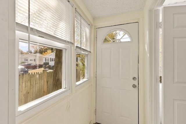 entryway featuring a textured ceiling