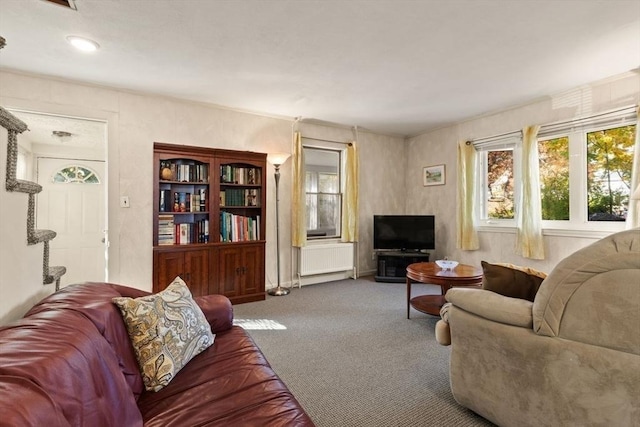 living area with carpet and radiator