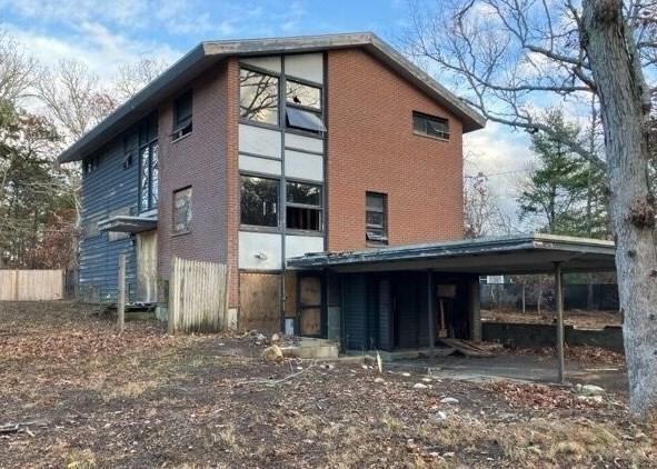 back of property with a carport