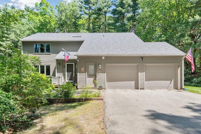 187 Middle Rd, Southborough, MA 01772 - view of front of house featuring driveway, a garage, a shingled roof, and a chimney